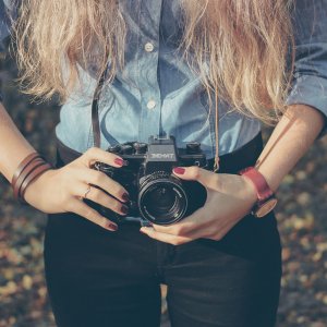 Woman with vintage retro camera Woman with vintage retro camera