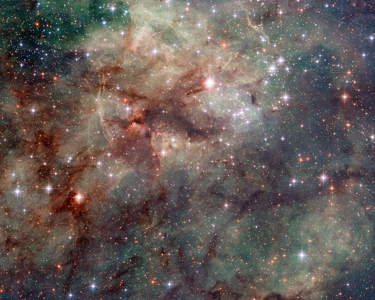 Hubble has taken this stunning close-up shot of part of the Tarantula Nebula. This star-forming region of ionised hydrogen gas is in the Large Magellanic Cloud, a small galaxy which neighbours the Milky Way. It is home to many extreme conditions including supernova remnants and the heaviest star ever found. The Tarantula Nebula is the most luminous nebula of its type  in the local Universe.